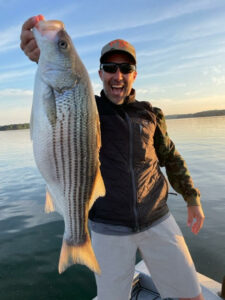 ralph hillard a client holding a large striped bass