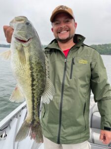 client holding a large spotted bass