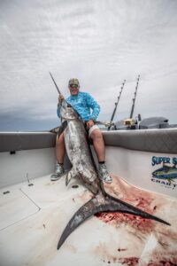 stew holding a marlin